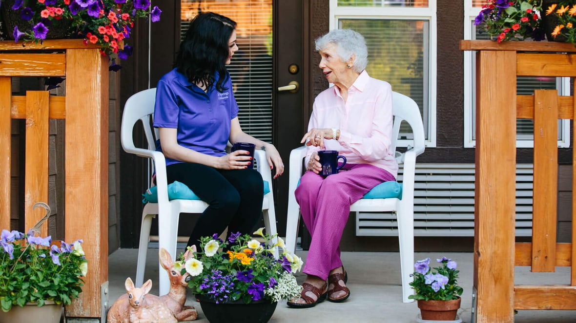 Caregiver and resident talking outside