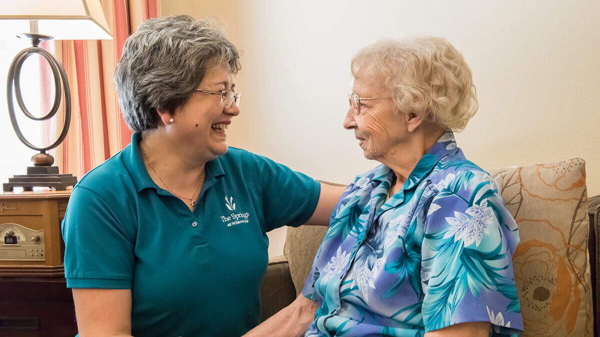 Care giver talking with a resident at the Wilsonville community