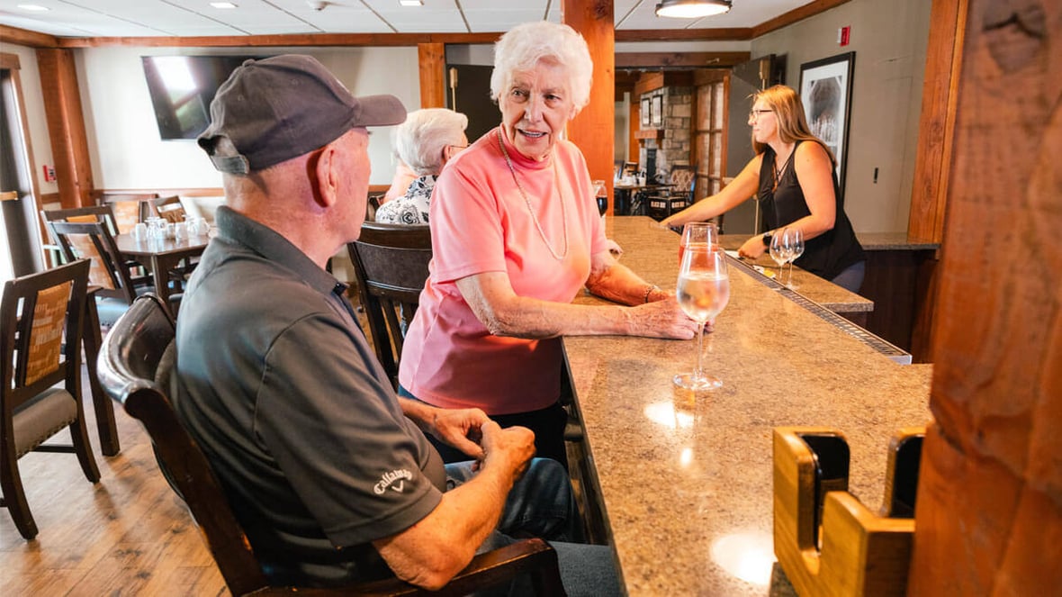 Two residents at the bar at the Butte community