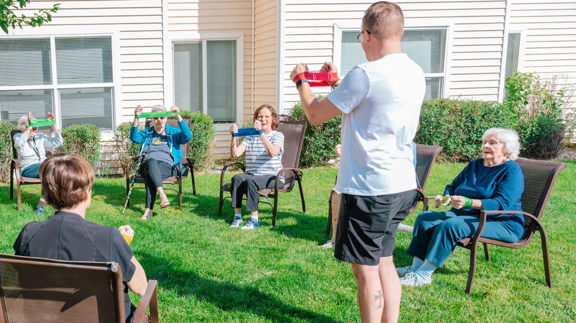 Residents enjoying outdoor fitness class at the Butte community