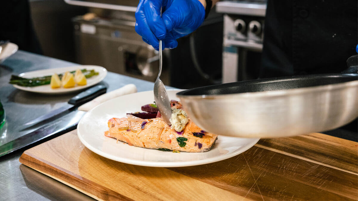 Chef preparing a dish at the Bozeman community