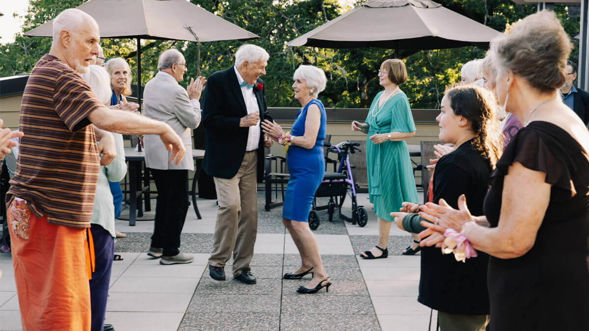 Residents dancing outside Carman Oaks community