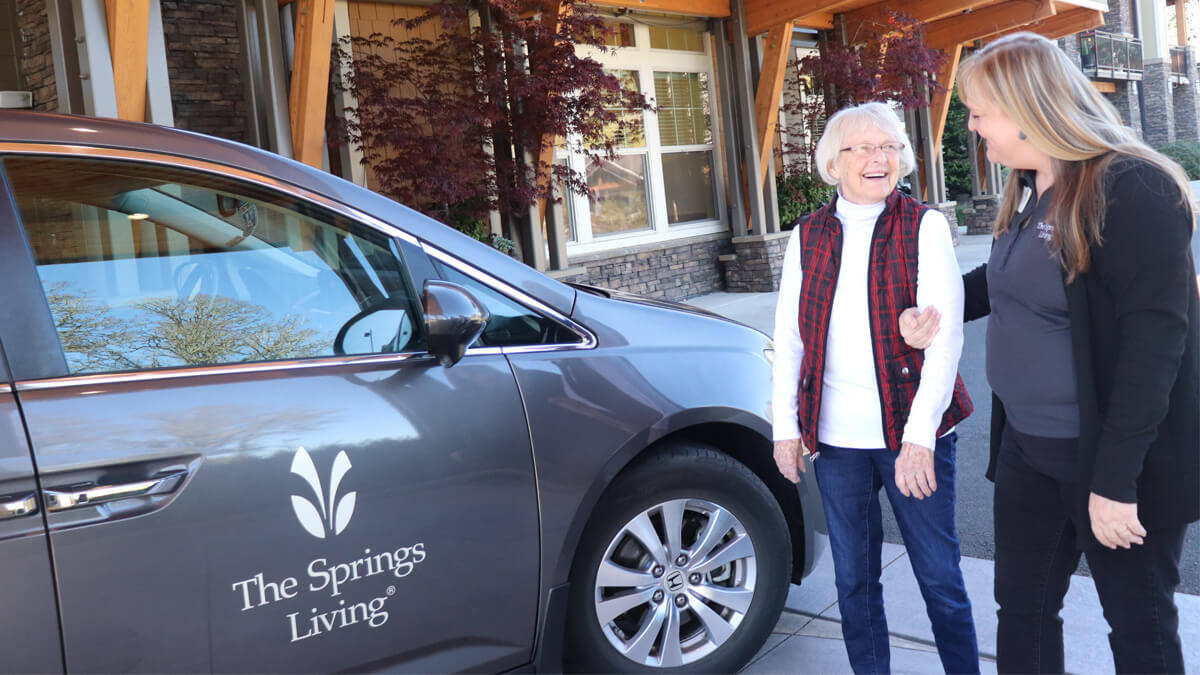 Resident and care giver going on an outing at the Lancaster Village community