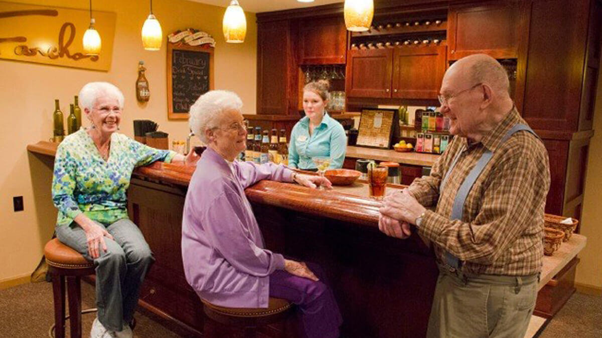 Residents sitting at the bar enjoying drinks