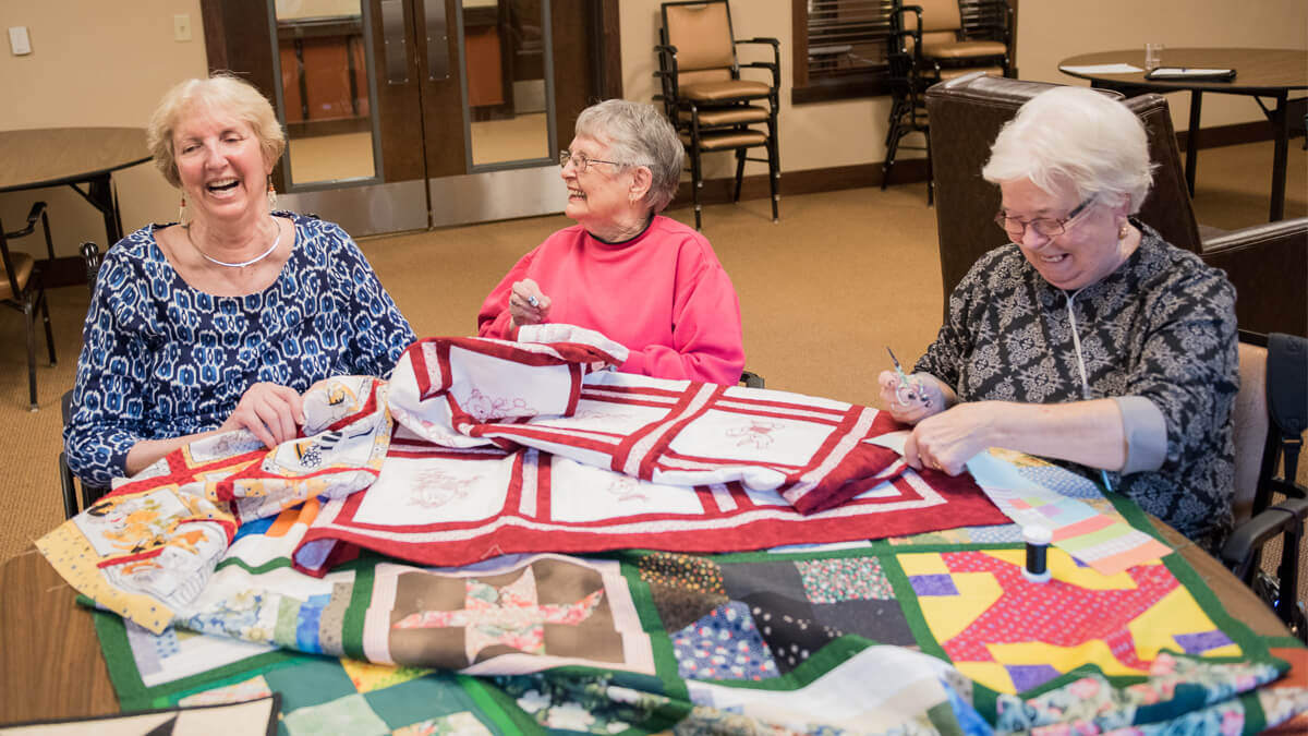 Residents enjoying craft time at the Anna Maria community