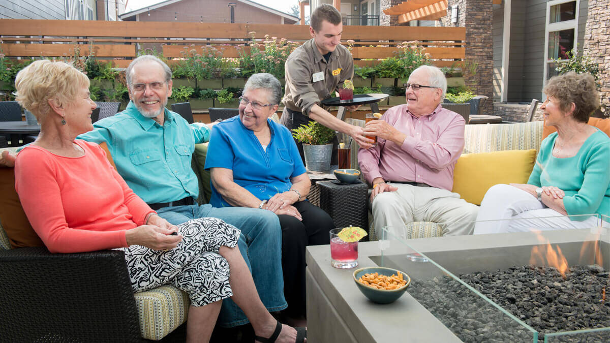 Residents receiving drinks at an outside patio