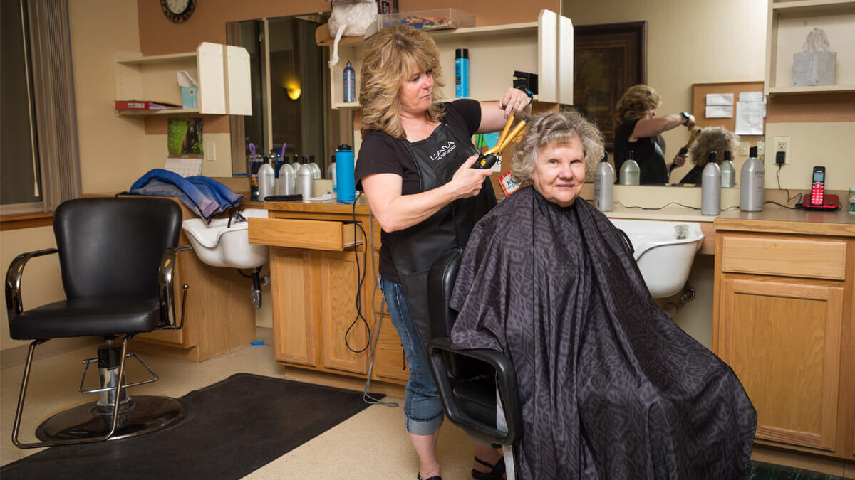 Resident getting a haircut at the Whitefish community
