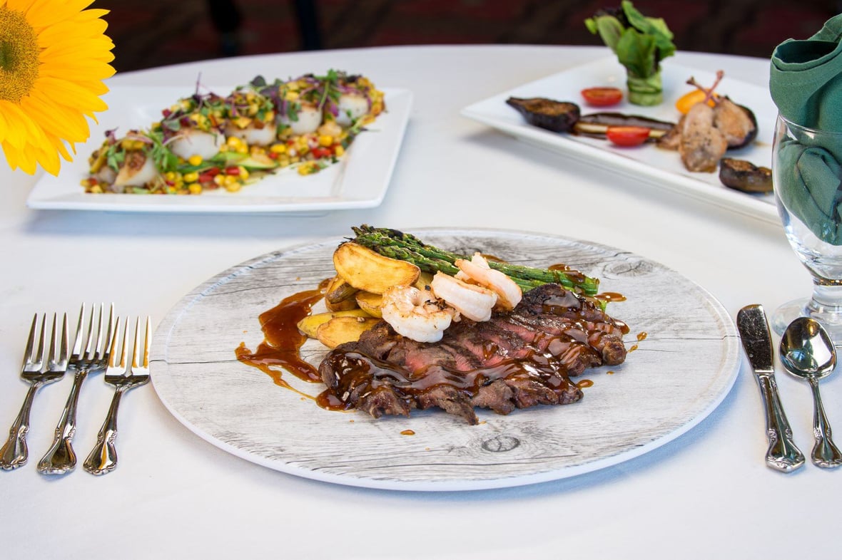 Steak, shrimp, and potatoes on a dinner plate