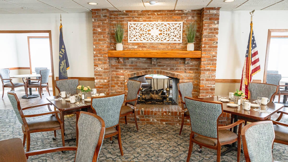 Dining room with a fireplace at the Lancaster Village community