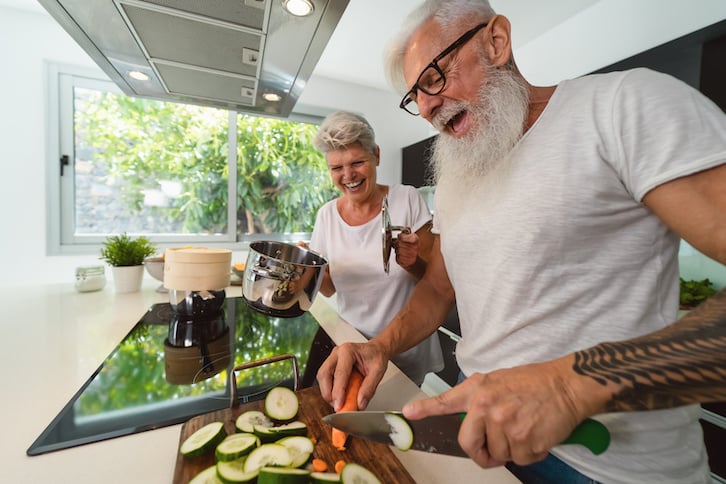 happy-senior-couple-having-fun-cooking-together-learning-eathing-right